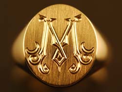 Hand engraved signet ring with a victorian M Engraved Oval Signet Ring